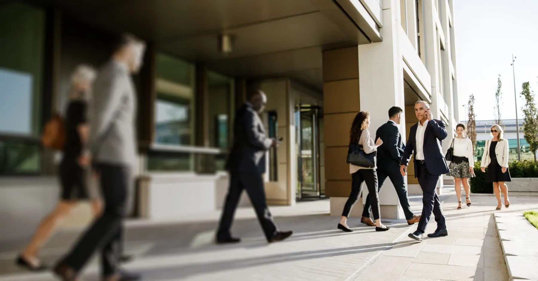 Office workers walking outside the Jersey International Finance Centre building