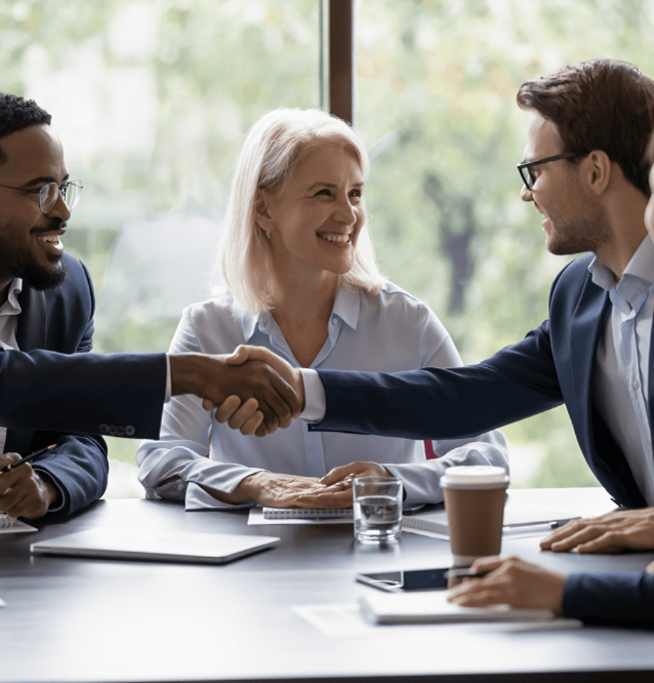 Smiling diverse businesspeople shake hands get acquainted greeting at customer meeting in office.